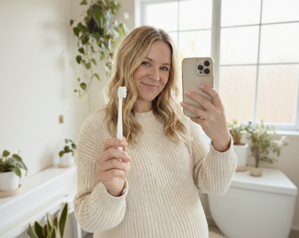 Pregnant woman holding Dentine Care Mommy Brush ultra soft nano bristle toothbrush for sensitive and bleeding gums during pregnancy