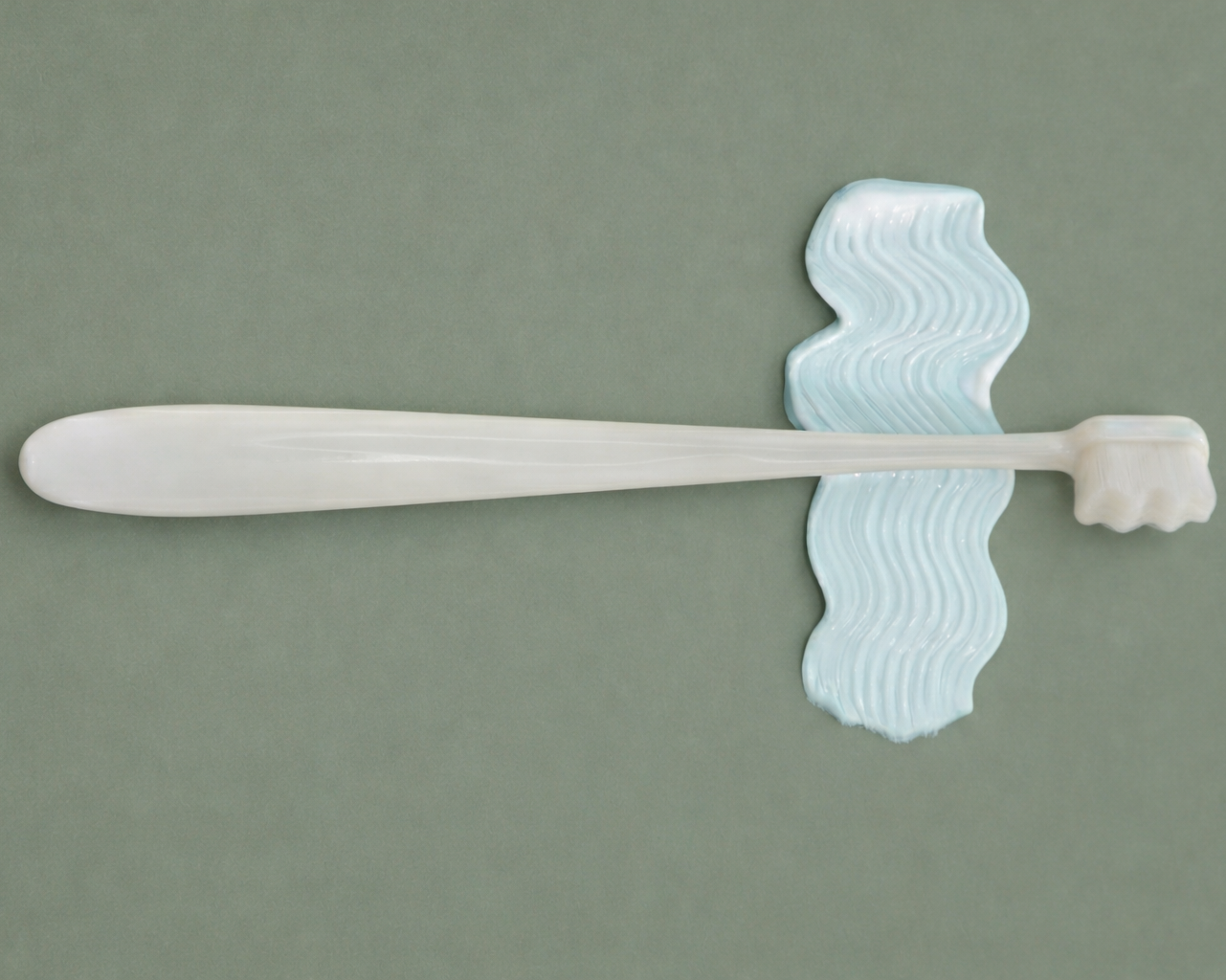 Minimalist soft white toothbrush with smooth blue toothpaste texture, premium gentle oral care design by Dentine Care.